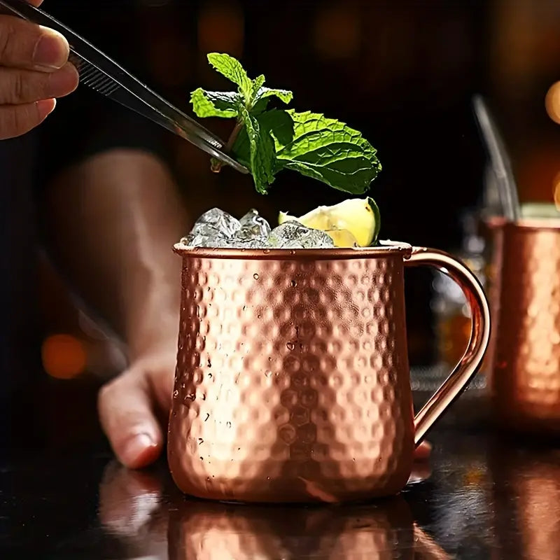 Classic Stainless Moscow Mule Mug With Hammered Copper Exterior Pattern | Oak & Sugar | The Classic Stainless Moscow Mule Mug: Where Luxe Meets Fizz Calling all cocktail connoisseurs and aficionados of extraordinary experiences! Are you ready to elevate y